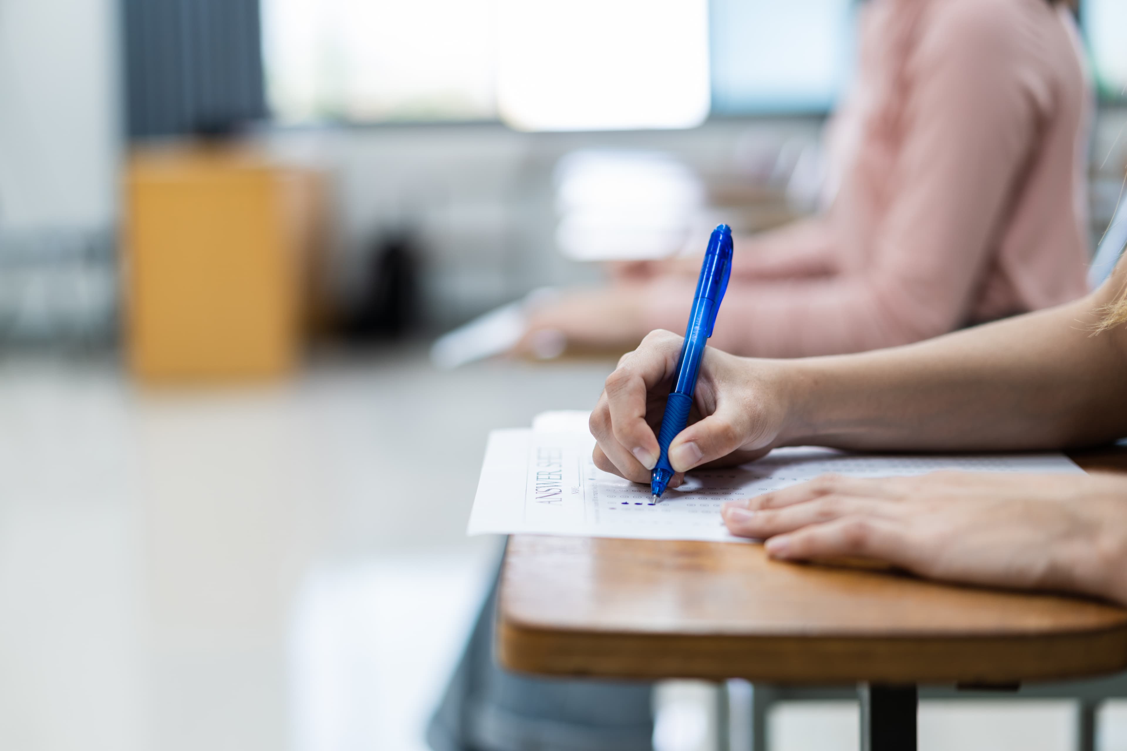 close-up-young-female-university-students-concentrate-doing-examination-classroom-girl-student-writes-answer-examinations-answer-sheet-classroom.jpg
